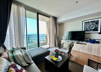 Bright and cozy living room with balcony access showing ocean view