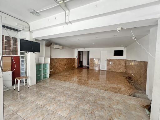 Spacious multi-purpose room with tiled flooring and modern amenities