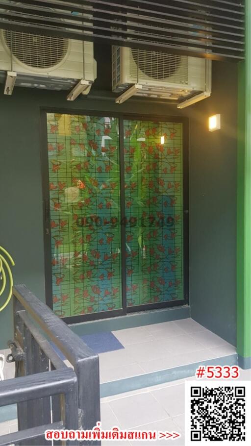 Elegant entrance with decorative glass door and modern air conditioning unit