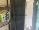 Compact kitchen area with refrigerator and storage shelves