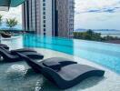 Luxurious rooftop infinity pool with ocean view and sun loungers