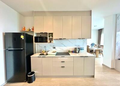 Modern kitchen with marble countertops and stainless steel appliances