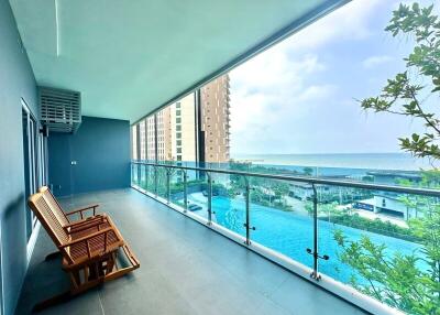 Spacious balcony with ocean view and swimming pool