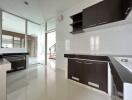 Modern kitchen with white and dark cabinetry and glossy tiles