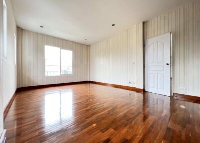 Spacious and bright living room with wooden flooring