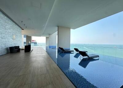 Luxurious indoor pool with ocean view in modern building