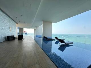 Luxurious indoor pool with ocean view in modern building