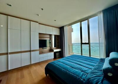Modern bedroom with ocean view and built-in cabinetry