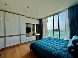 Modern bedroom with ocean view and built-in cabinetry