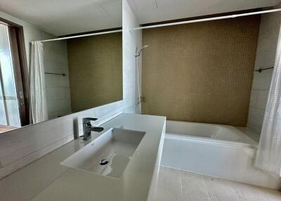 Spacious bathroom with sink and bathtub