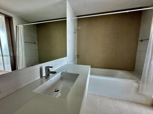 Spacious bathroom with sink and bathtub