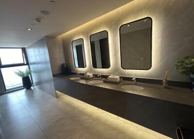 Spacious modern bathroom with multiple sinks and large mirrors