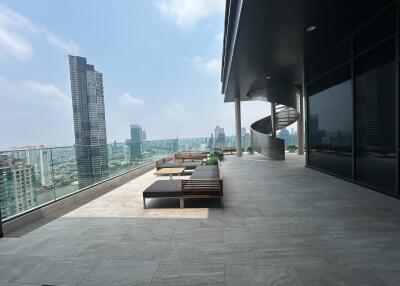 Spacious balcony with modern outdoor furniture and city skyline view