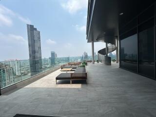 Spacious balcony with modern outdoor furniture and city skyline view