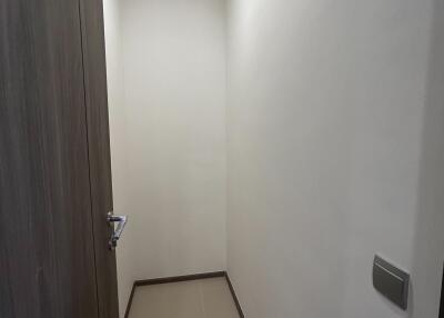 Narrow residential hallway with wooden door