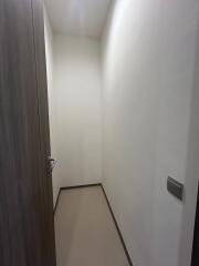 Narrow residential hallway with wooden door