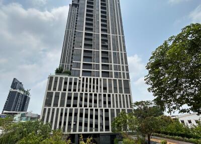 Modern high-rise residential building with landscaped surroundings