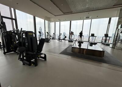 Spacious high-rise gym with city views and modern equipment