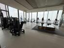Spacious high-rise gym with city views and modern equipment