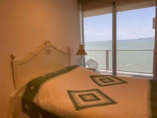 Cozy bedroom with sea view through large window
