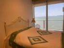 Cozy bedroom with sea view through large window