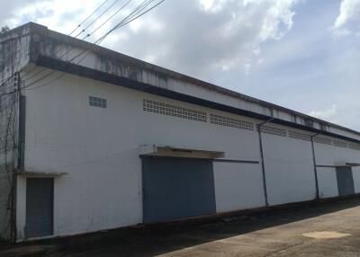 Large industrial warehouse exterior with multiple gated entries