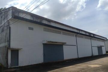 Large industrial warehouse exterior with multiple gated entries
