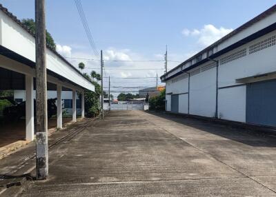 Spacious outdoor area with covered parking and clear skies