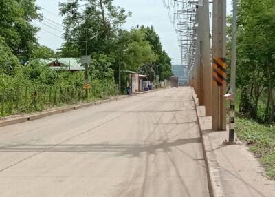 Street view near the property with surrounding greenery and residential area