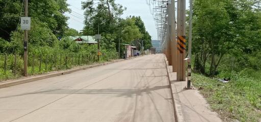 Street view near the property with surrounding greenery and residential area