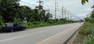 Image of a street scene with electrical power lines and passing vehicles