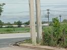 rural roadside view with power lines and agriculture field