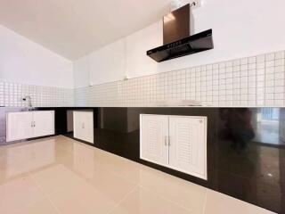 Modern kitchen with white cabinetry and black countertops