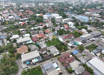 Aerial view of a dense residential neighborhood with a mix of houses and green spaces