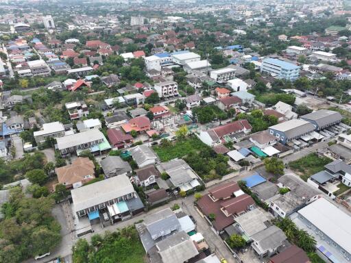 Aerial view of a dense residential neighborhood with a mix of houses and green spaces