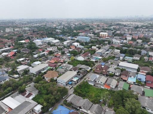 Aerial view of a residential area with diverse housing and lush greenery