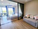 Spacious bedroom with sliding door access to balcony and modern furniture