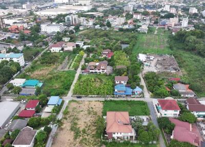 Aerial view of a lush residential neighborhood with a mix of houses and green spaces
