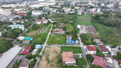 Aerial view of a lush residential neighborhood with a mix of houses and green spaces