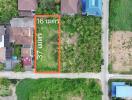 Aerial view of a vacant land plot outlined for property development