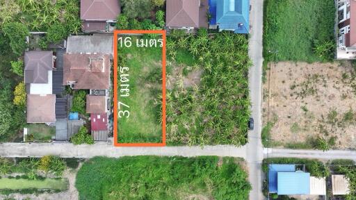 Aerial view of a vacant land plot outlined for property development