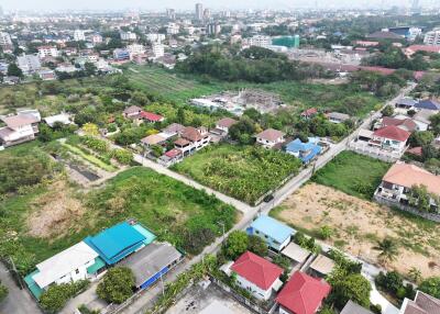 Aerial view of a residential area with various properties and green spaces