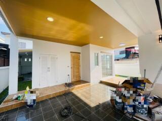 Spacious covered patio area with colorful walls and tile flooring