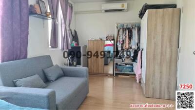 Spacious bedroom with sofa and wardrobes