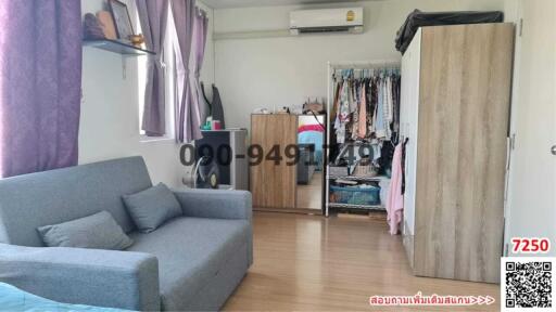 Spacious bedroom with sofa and wardrobes