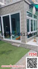 Modern gray stone finished building with large glass windows and sliding doors