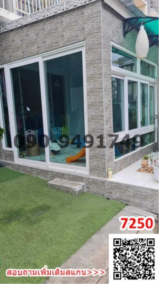 Modern gray stone finished building with large glass windows and sliding doors