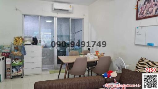 Spacious living room with dining area, sliding glass doors, and a sofa