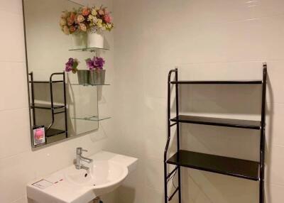 Modern bathroom with decorative flowers and sleek fixtures