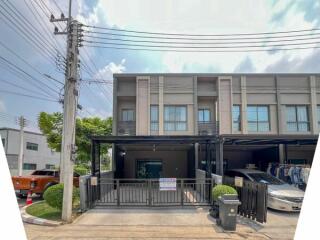 Modern two-story residential building with external car parking